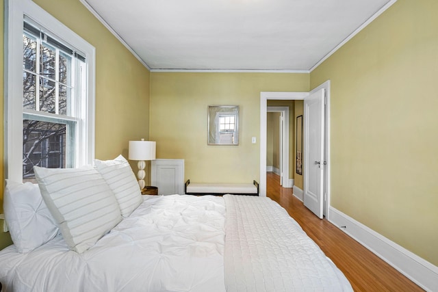 bedroom with hardwood / wood-style flooring and ornamental molding