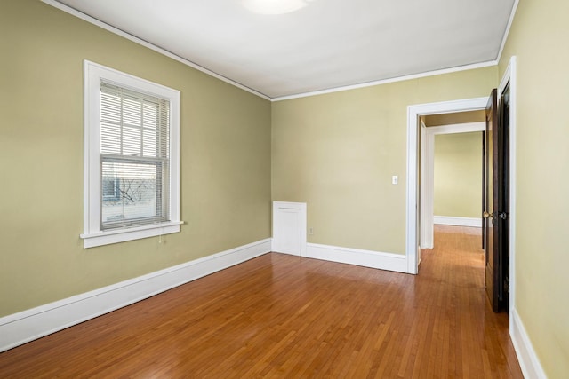 unfurnished room featuring hardwood / wood-style floors and ornamental molding