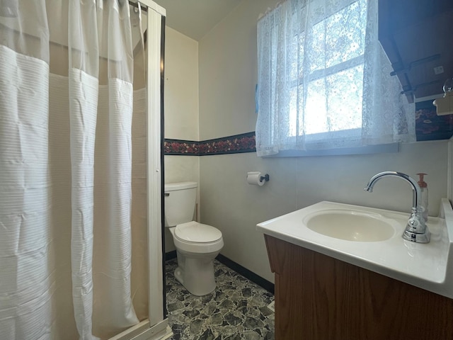 bathroom with vanity, toilet, and walk in shower