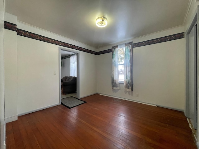 interior space with hardwood / wood-style flooring and ornamental molding