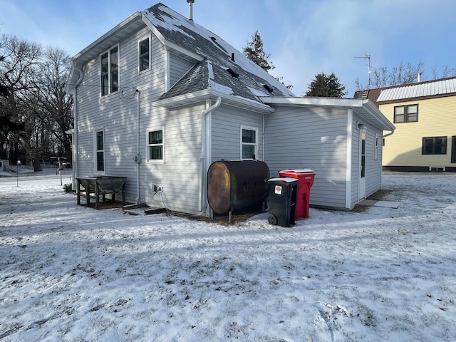 view of snow covered rear of property