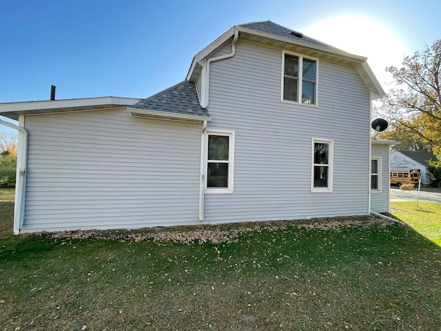 view of side of property featuring a yard