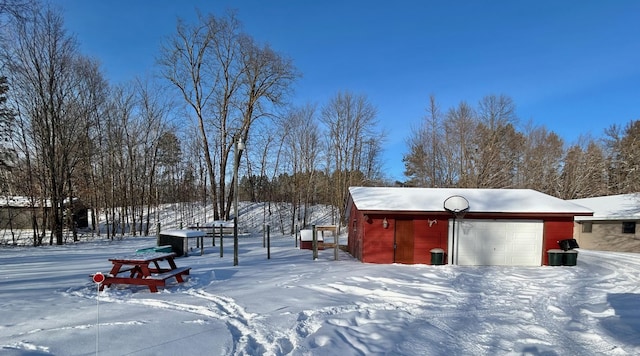 exterior space with a garage and an outbuilding