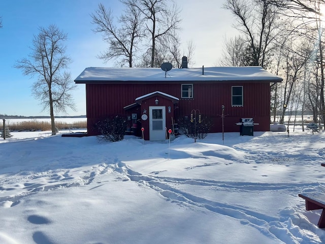 view of snow covered rear of property