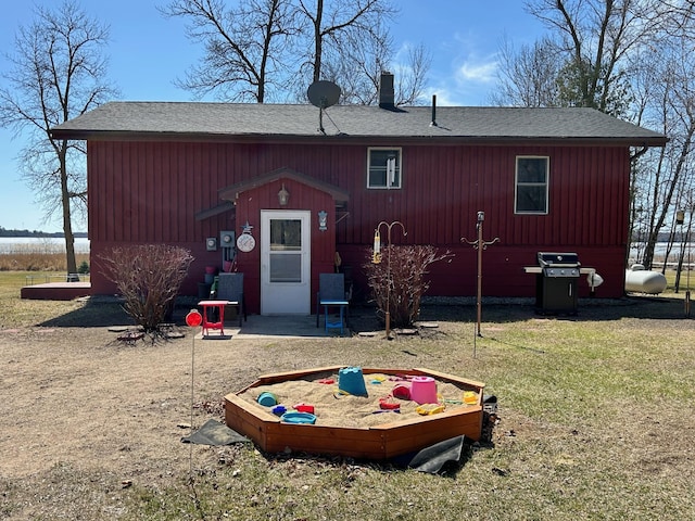 19162 Coho Loop NE, Blackduck, MN 56647 - rear view of property featuring a lawn, a chimney, and roof with shingles