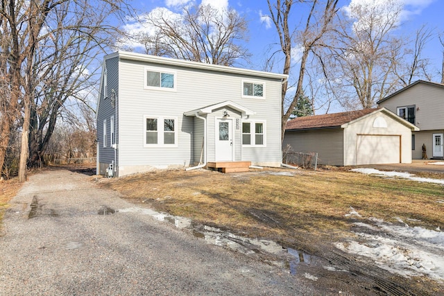 view of front property with an outbuilding and a garage