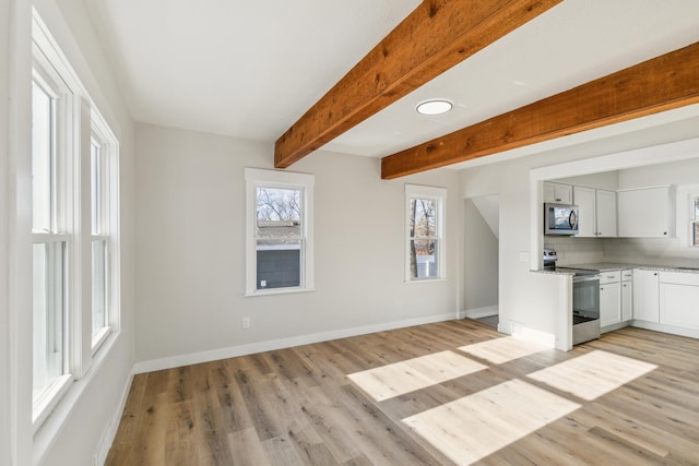 unfurnished living room featuring beam ceiling and light wood-type flooring