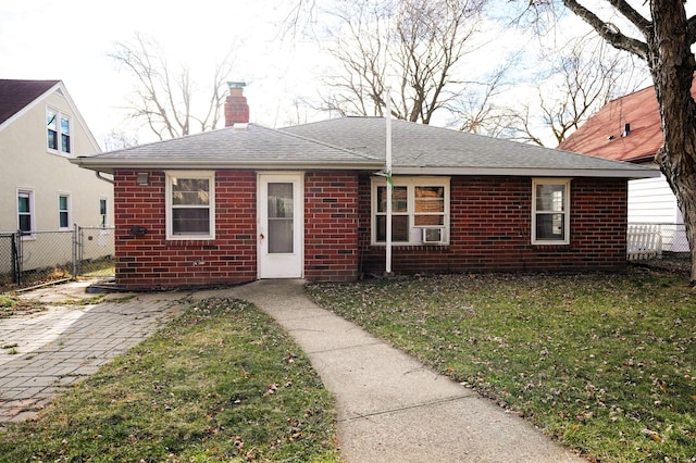 view of front of house with a front yard and cooling unit