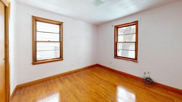 spare room with hardwood / wood-style floors