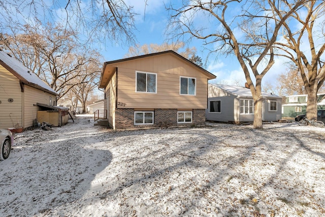 view of snow covered rear of property