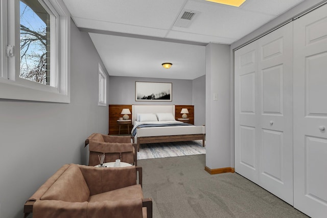 bedroom featuring carpet floors, baseboards, visible vents, and a closet
