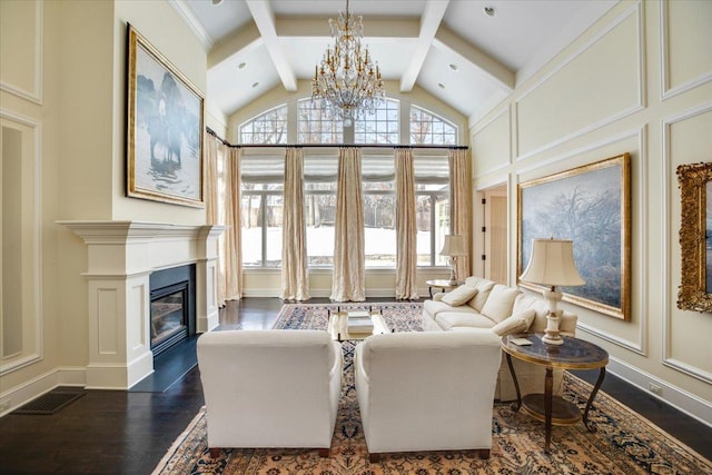 living room featuring a notable chandelier, beam ceiling, dark wood-type flooring, and high vaulted ceiling