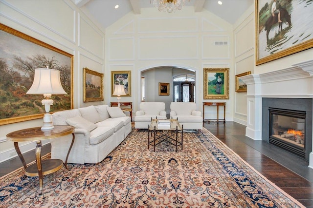 living room with beamed ceiling, high vaulted ceiling, a chandelier, and dark hardwood / wood-style flooring