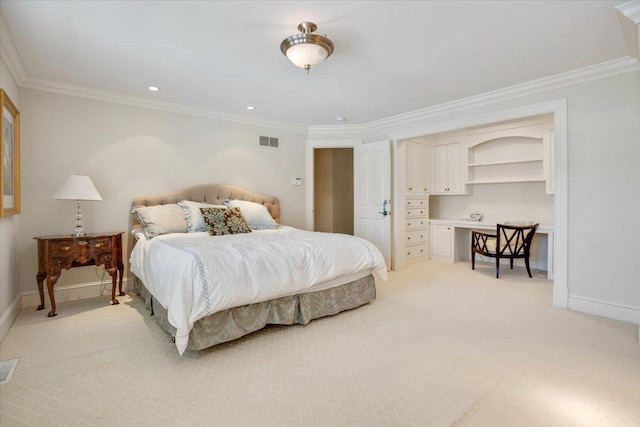 carpeted bedroom with ornamental molding and built in desk