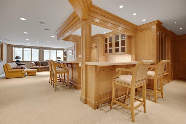 bar featuring crown molding and light carpet