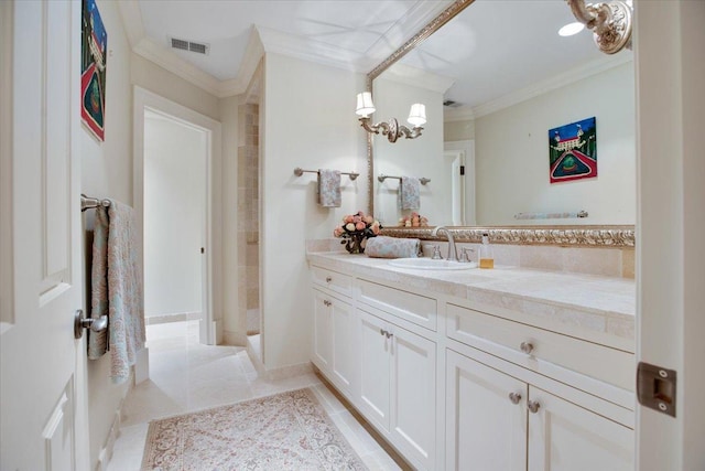 bathroom featuring tile patterned flooring, crown molding, and vanity