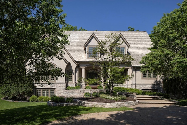 english style home with a front yard