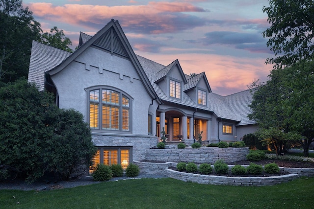 back house at dusk with a yard