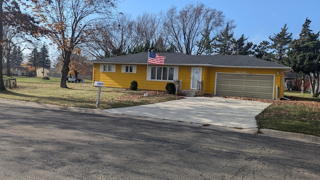 ranch-style home with a garage and a front lawn