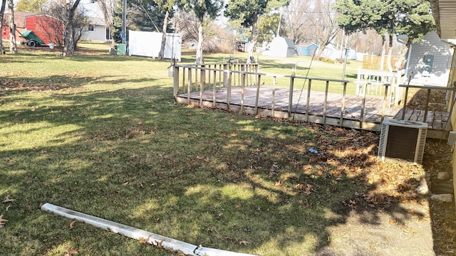 view of yard featuring central air condition unit and a deck