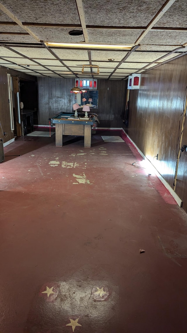 basement featuring billiards and wood walls