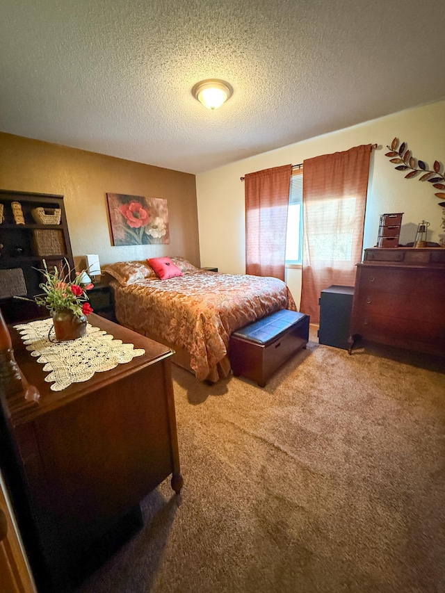 carpeted bedroom featuring a textured ceiling