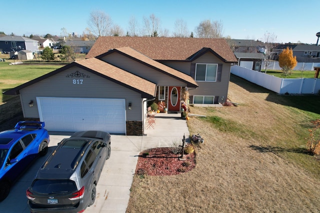 view of front of house with a garage and a front lawn