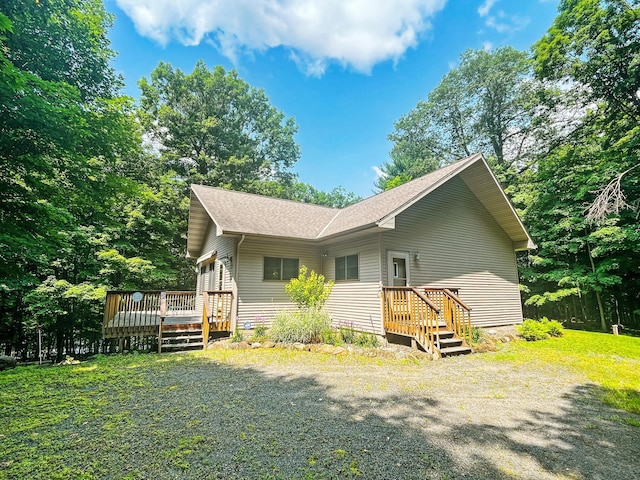 rear view of property with a wooden deck