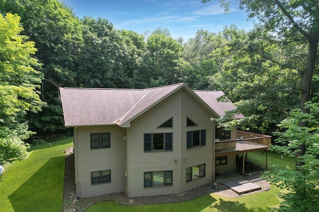 exterior space featuring a patio area, a deck, and a yard