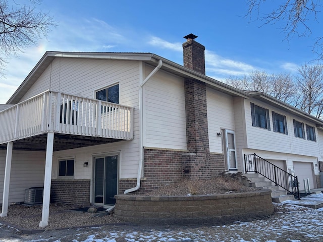 exterior space with a garage and central AC