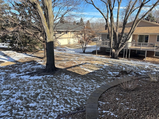 yard covered in snow with a wooden deck