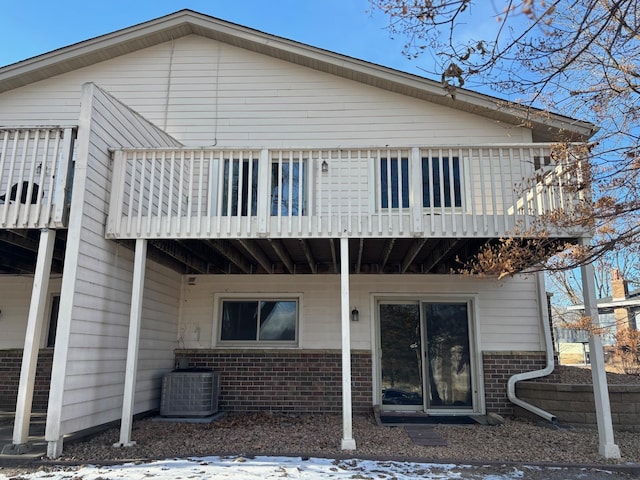 back of property featuring cooling unit and a balcony