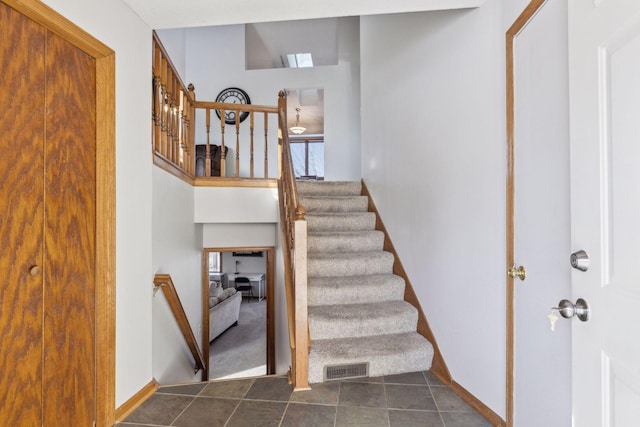 staircase with tile patterned floors