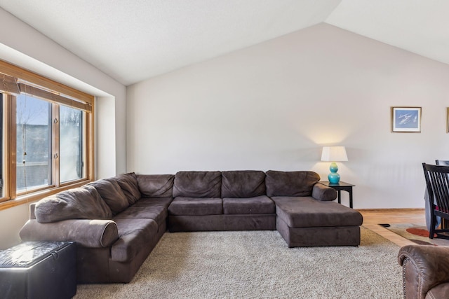 living room with carpet and vaulted ceiling