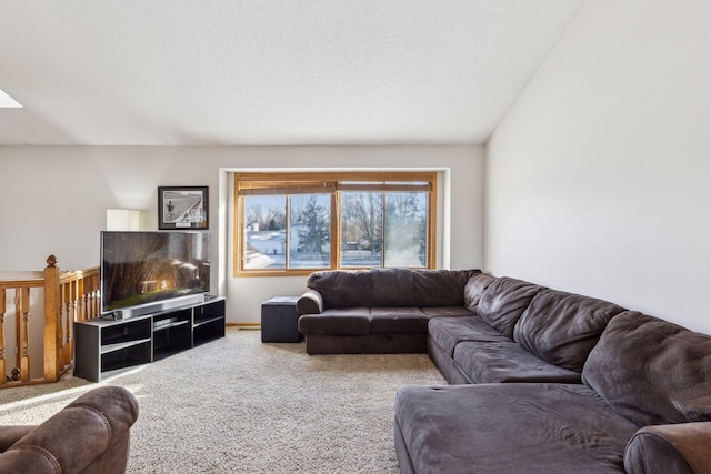 living room featuring a textured ceiling, carpet floors, and lofted ceiling