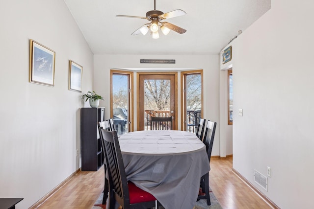 dining area with vaulted ceiling, light hardwood / wood-style flooring, and ceiling fan