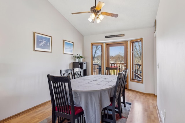 dining space featuring ceiling fan, light hardwood / wood-style floors, and vaulted ceiling