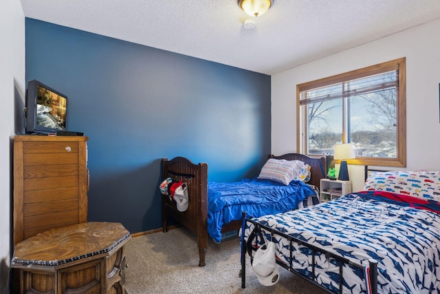 carpeted bedroom featuring a textured ceiling