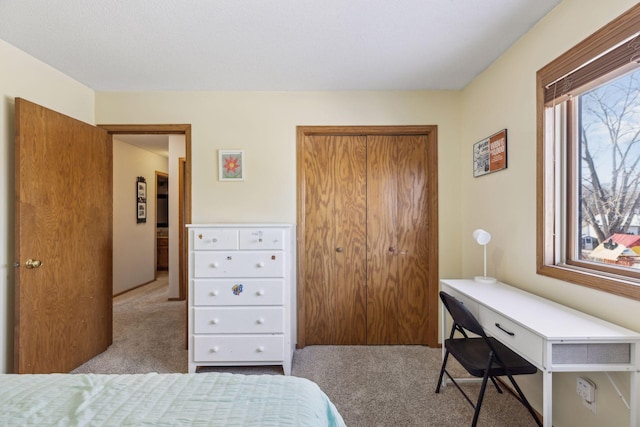 carpeted bedroom with a closet