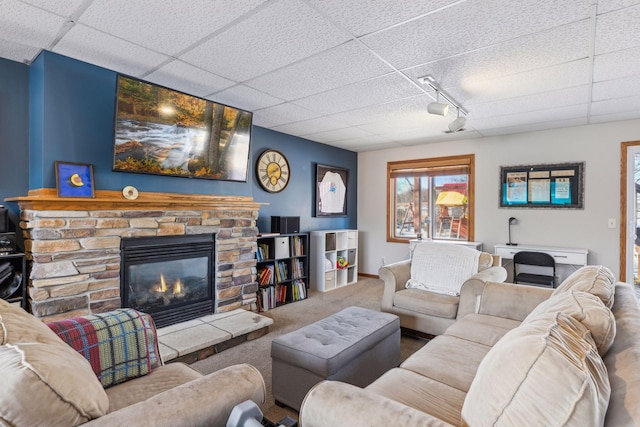 living room featuring a fireplace, a paneled ceiling, and carpet floors