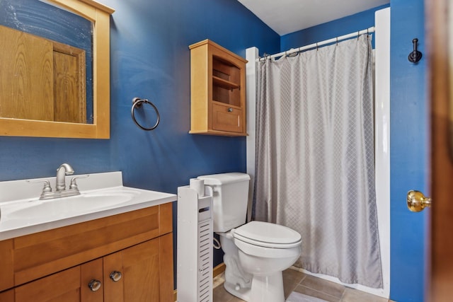 bathroom featuring tile patterned flooring, vanity, a shower with shower curtain, and toilet