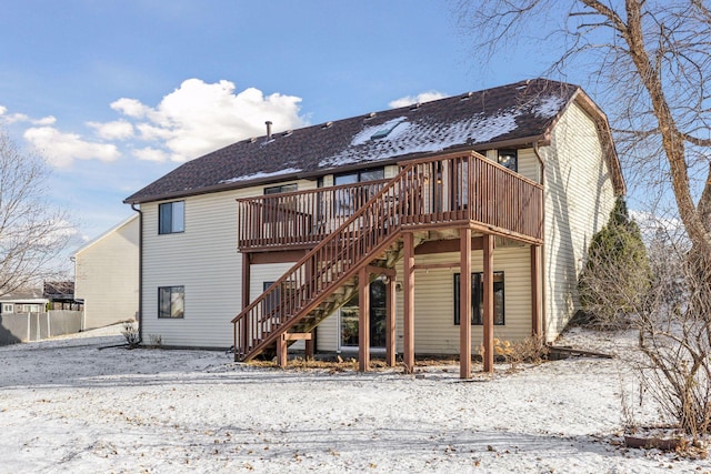 snow covered property featuring a wooden deck