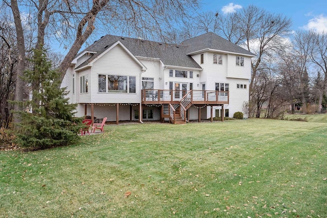 rear view of property featuring a yard and a deck