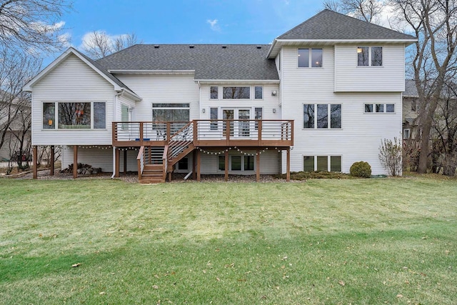 back of house featuring a lawn and a deck