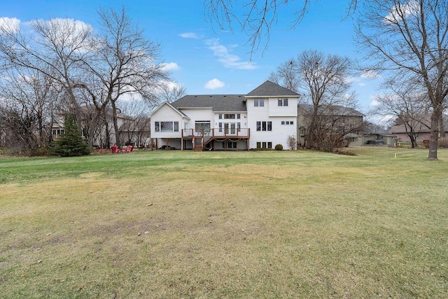 back of house with a wooden deck and a yard