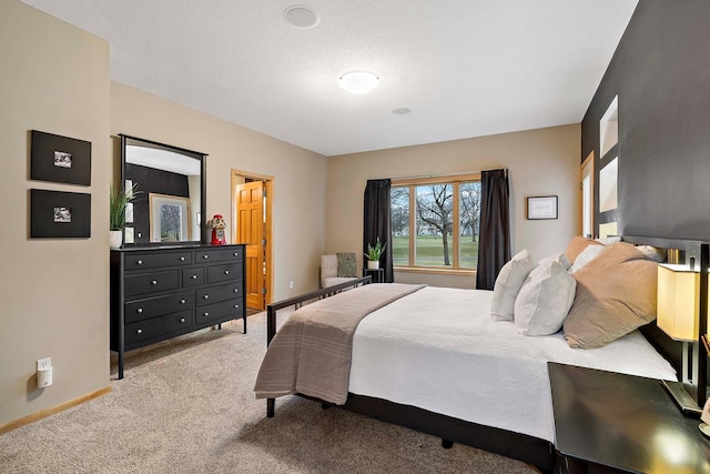 carpeted bedroom featuring a textured ceiling