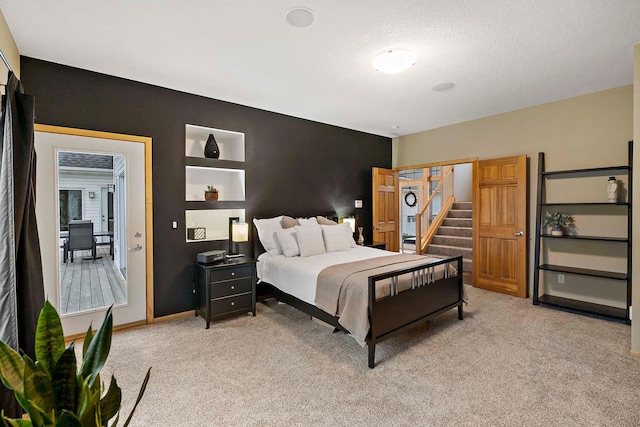 carpeted bedroom featuring a textured ceiling