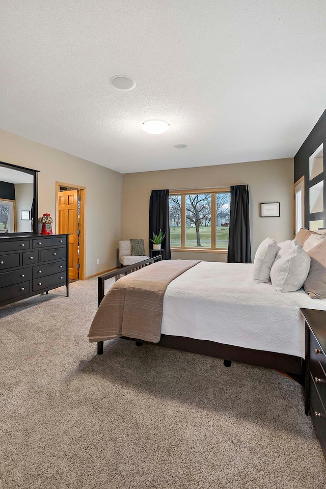 carpeted bedroom with a textured ceiling