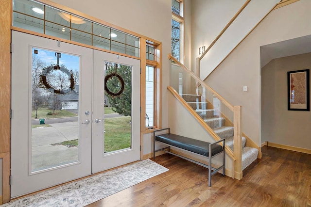 entryway featuring french doors, hardwood / wood-style flooring, and plenty of natural light