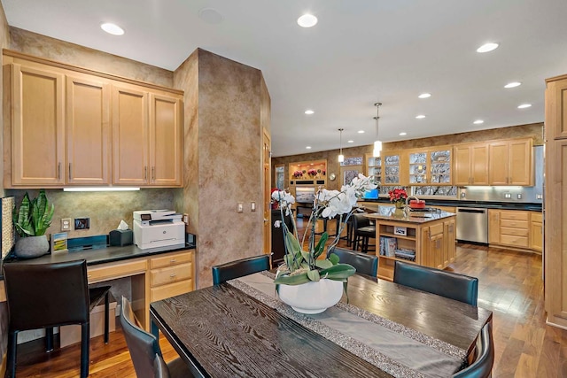 dining room featuring sink and light hardwood / wood-style flooring